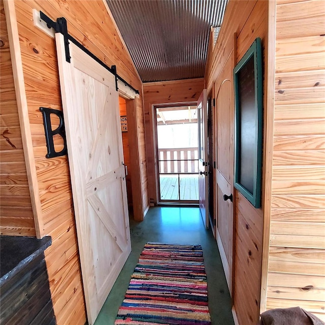 1432 Wayne 523, Wappapello, MO 63966 - hall featuring a barn door, wood walls, and concrete floors