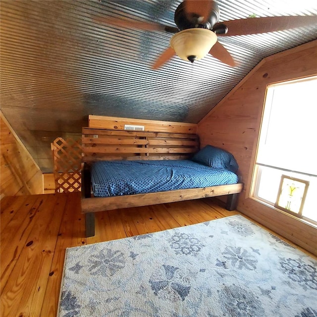 1432 Wayne 523, Wappapello, MO 63966 - bedroom with vaulted ceiling, wooden walls, wood finished floors, and ceiling fan
