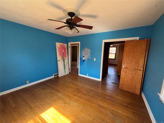 unfurnished bedroom with hardwood / wood-style floors, baseboards, and ceiling fan