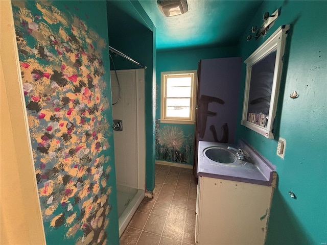 full bath featuring a stall shower, tile patterned flooring, and vanity