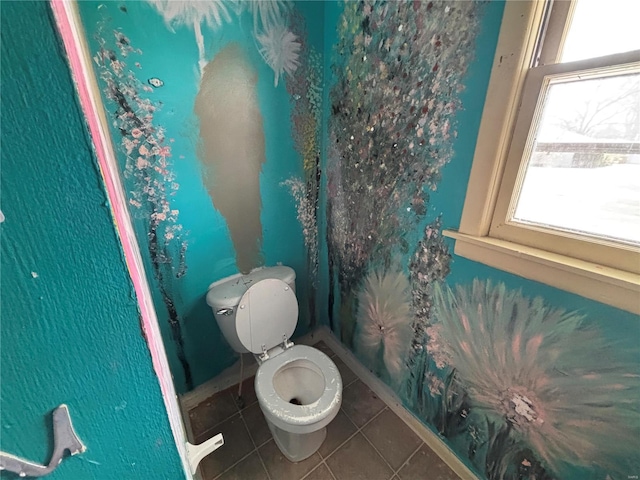 bathroom with tile patterned floors, healthy amount of natural light, and toilet