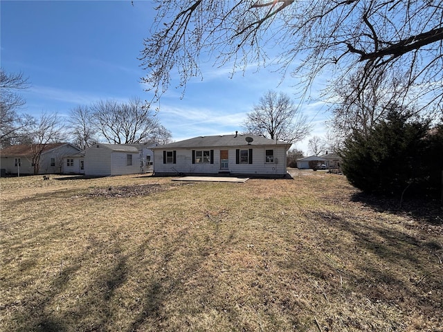 rear view of property featuring a lawn