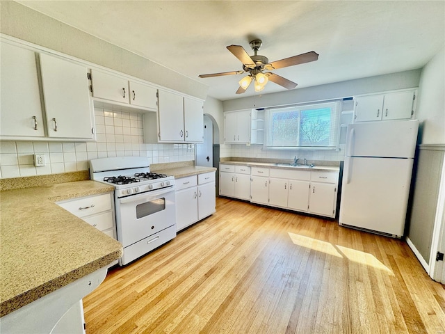 922 S 6th St, Belleville, IL 62220 - kitchen with white appliances, a sink, tasteful backsplash, light wood finished floors, and a ceiling fan