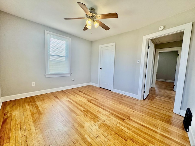 922 S 6th St, Belleville, IL 62220 - unfurnished bedroom with light wood-type flooring, attic access, baseboards, ceiling fan, and a closet
