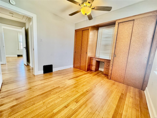 922 S 6th St, Belleville, IL 62220 - unfurnished bedroom featuring light wood-style floors, two closets, ceiling fan, and baseboards