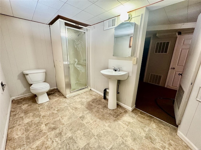 922 S 6th St, Belleville, IL 62220 - full bath featuring a stall shower, toilet, and wood walls