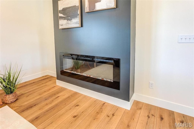 detailed view of baseboards and wood finished floors
