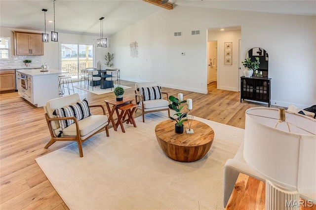 living area featuring light wood-style flooring, baseboards, and recessed lighting