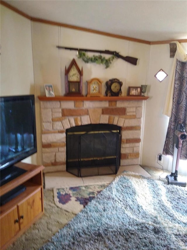 living room with crown molding and a stone fireplace