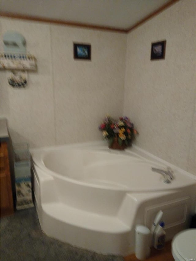 full bathroom with a bath, toilet, and a textured wall