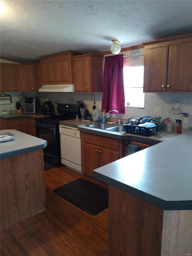 kitchen featuring range with electric stovetop, dishwasher, dark wood finished floors, a textured ceiling, and brown cabinetry