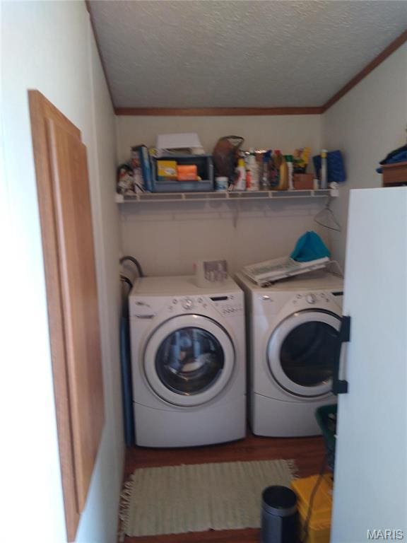 1030 Butler Rd, Tilden, IL 62292 - clothes washing area featuring washer and dryer, a textured ceiling, wood finished floors, and ornamental molding
