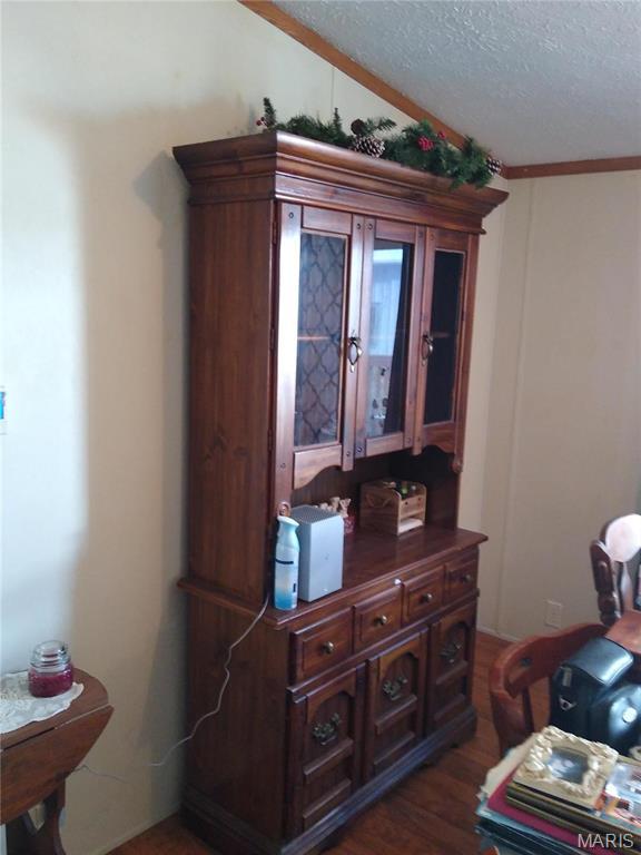 1030 Butler Rd, Tilden, IL 62292 - detailed view of wood finished floors, a textured ceiling, and crown molding