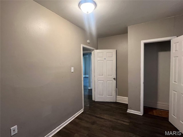 5109 Cote Brilliante Ave, Saint Louis, MO 63113 - unfurnished bedroom featuring dark wood finished floors and baseboards