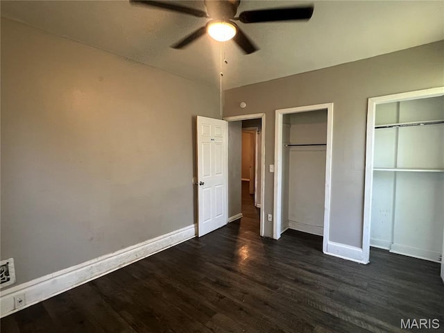 5109 Cote Brilliante Ave, Saint Louis, MO 63113 - unfurnished bedroom featuring two closets, dark wood-style floors, and ceiling fan