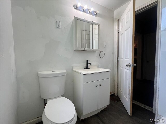 5109 Cote Brilliante Ave, Saint Louis, MO 63113 - half bathroom featuring vanity and wood finished floors