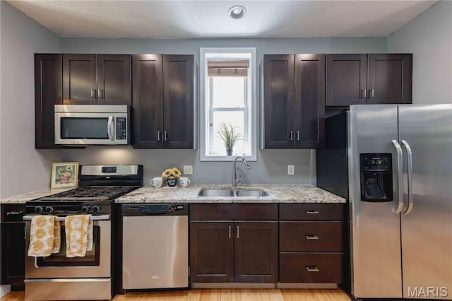 2244 Nebraska Ave, Saint Louis, MO 63104 - kitchen featuring stainless steel appliances, dark brown cabinetry, light stone countertops, and recessed lighting