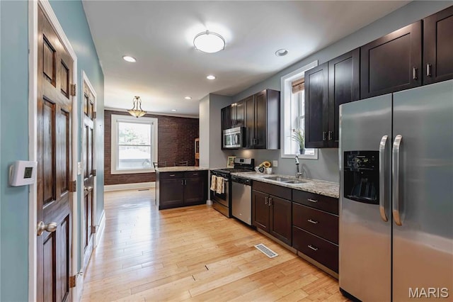 2244 Nebraska Ave, Saint Louis, MO 63104 - kitchen featuring stainless steel appliances, light wood-type flooring, a peninsula, dark brown cabinetry, and recessed lighting