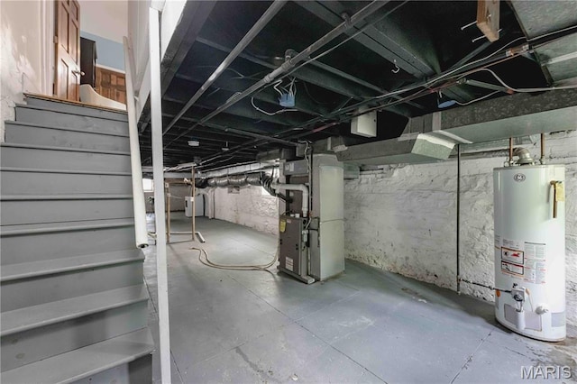 2244 Nebraska Ave, Saint Louis, MO 63104 - unfinished below grade area with water heater, heating unit, and stairway