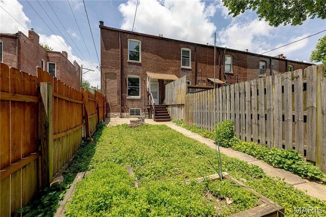 2244 Nebraska Ave, Saint Louis, MO 63104 - back of house with a fenced backyard and a garden