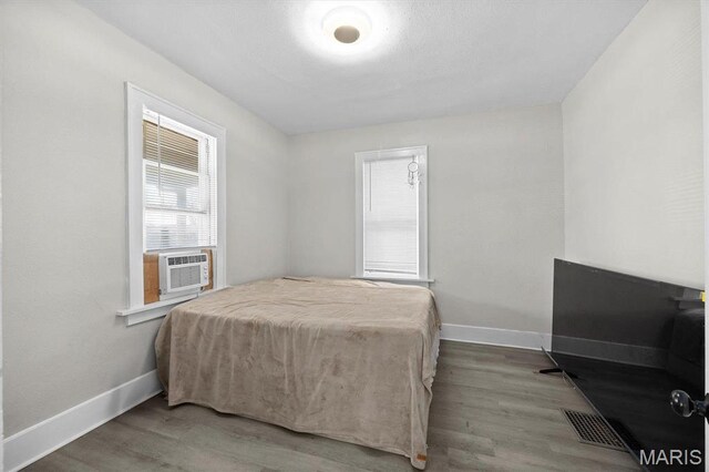 2339 Lincoln Ave, Granite City, IL 62040 - bedroom with baseboards, cooling unit, and wood finished floors