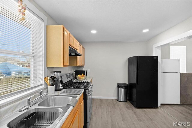 2339 Lincoln Ave, Granite City, IL 62040 - kitchen with freestanding refrigerator, stainless steel range with gas stovetop, under cabinet range hood, light wood-type flooring, and recessed lighting
