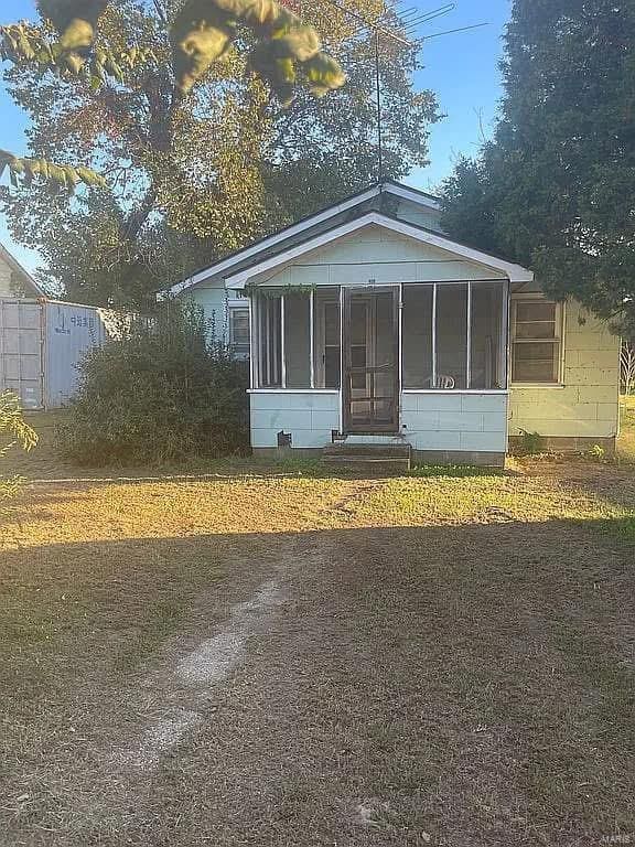 214 Charlotte Ave, Lilbourn, MO 63862 - rear view of property featuring a sunroom