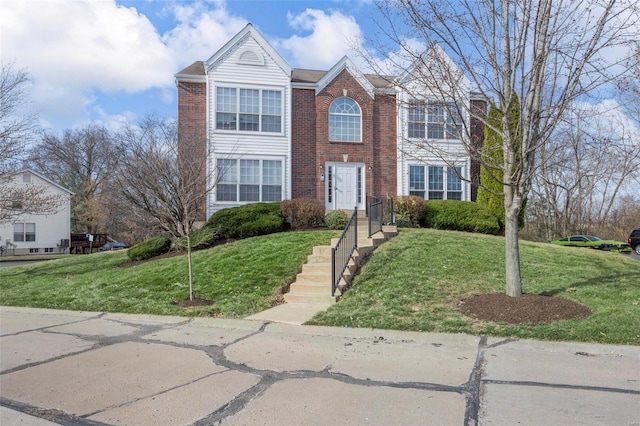 view of front of home featuring a front lawn, brick siding, and a chimney