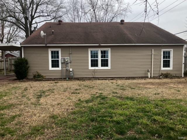 rear view of property with a lawn