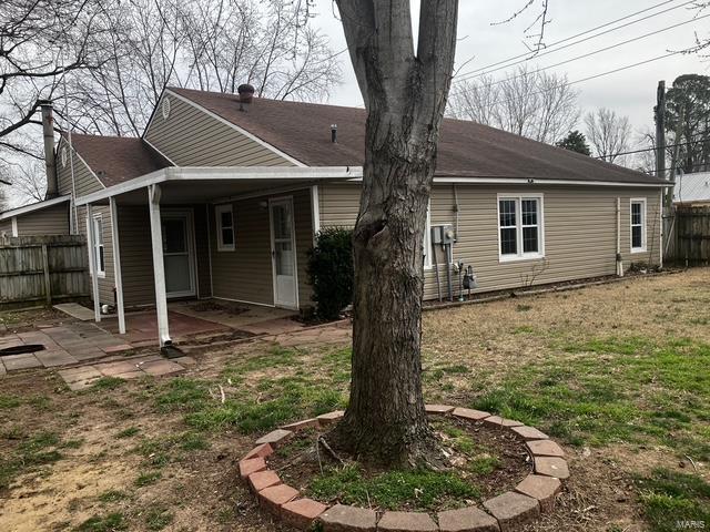 back of property with a patio