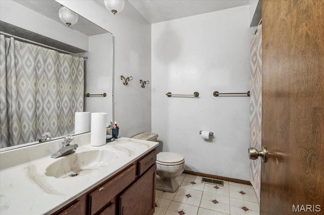 2208 Gillis St, Alton, IL 62002 - full bath featuring vanity, toilet, and baseboards
