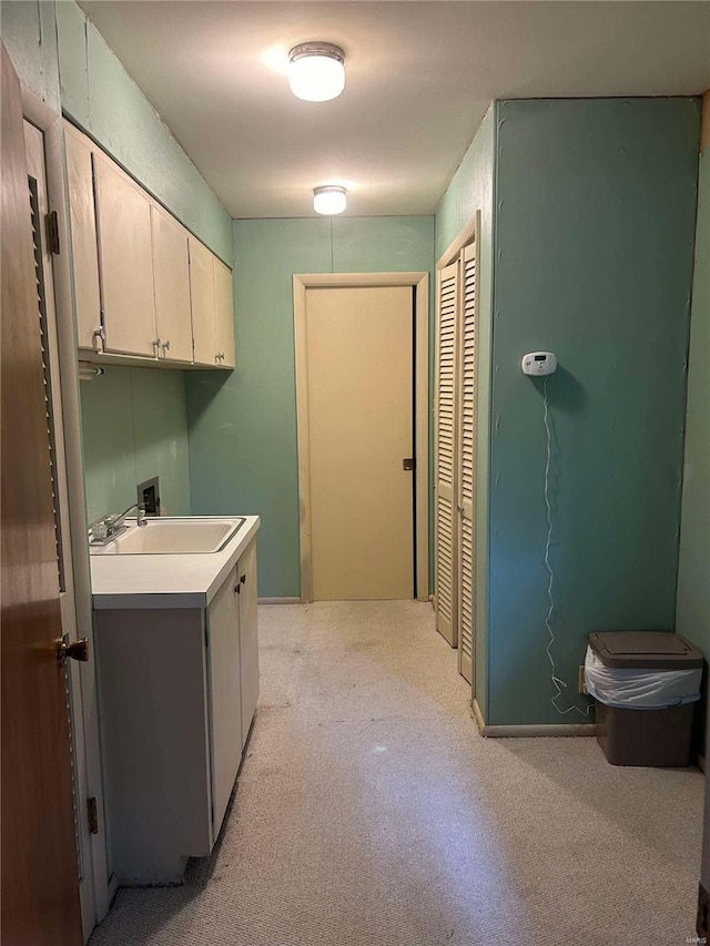 washroom with cabinet space, washer hookup, and light carpet