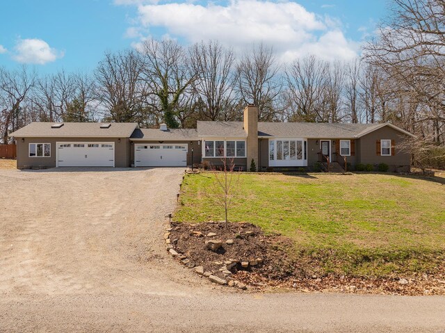 51 County Road 620a, Isabella, MO 65676 - ranch-style house with a chimney, driveway, a garage, and a front lawn