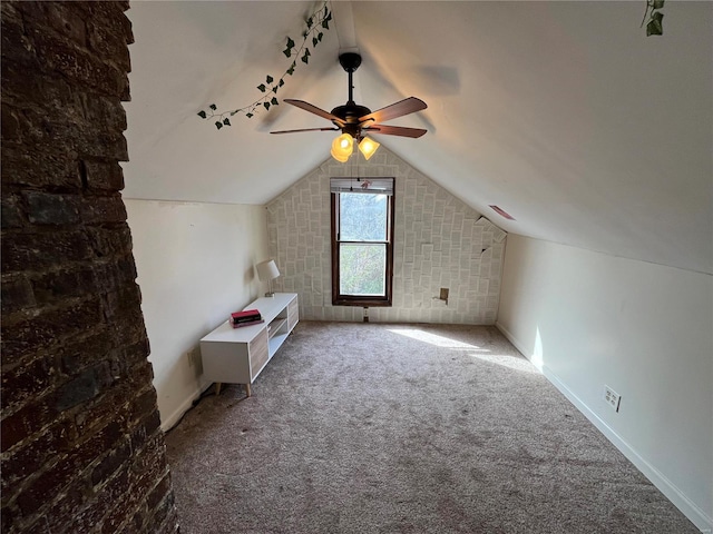 bonus room with a ceiling fan, lofted ceiling, carpet flooring, and baseboards