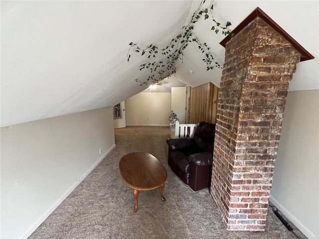 living area featuring carpet floors, vaulted ceiling, and baseboards