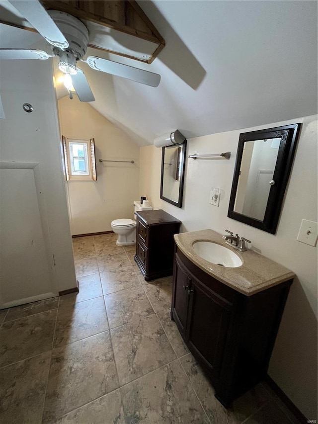 bathroom with ceiling fan, vaulted ceiling, toilet, vanity, and baseboards