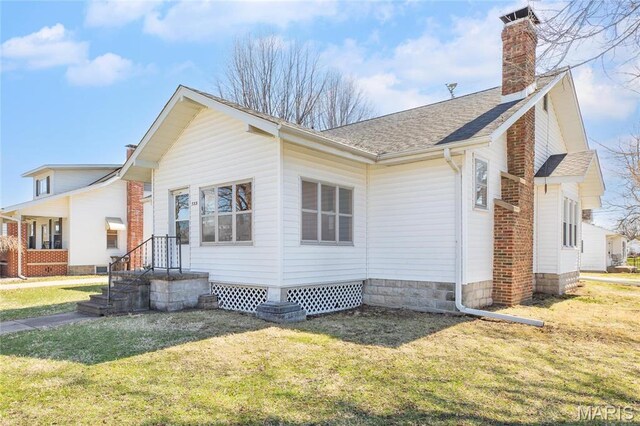 533 Locust St, Carrollton, IL 62016 - view of home's exterior featuring a yard, a chimney, and roof with shingles