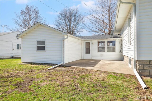 533 Locust St, Carrollton, IL 62016 - back of property featuring a patio area and a lawn