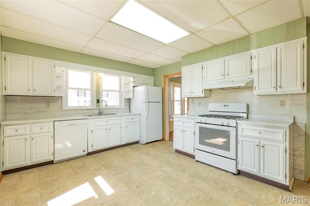 533 Locust St, Carrollton, IL 62016 - kitchen featuring white appliances, under cabinet range hood, a sink, light countertops, and white cabinets