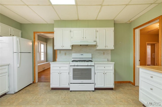 533 Locust St, Carrollton, IL 62016 - kitchen featuring white appliances, under cabinet range hood, light countertops, and white cabinetry