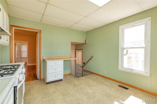 533 Locust St, Carrollton, IL 62016 - kitchen with white range with gas cooktop, plenty of natural light, light floors, light countertops, and a drop ceiling