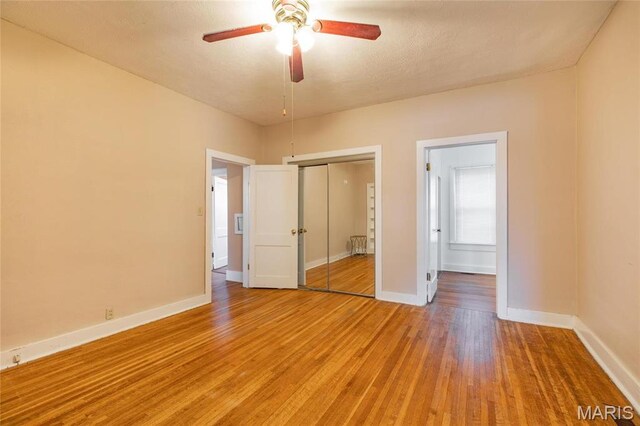 533 Locust St, Carrollton, IL 62016 - unfurnished bedroom with baseboards, light wood-type flooring, a closet, and ensuite bath
