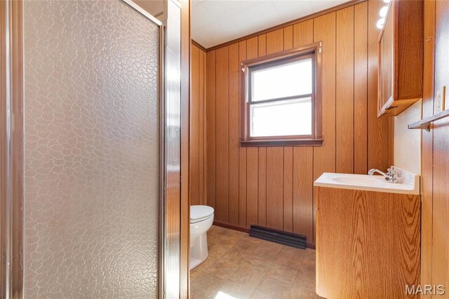 533 Locust St, Carrollton, IL 62016 - bathroom with vanity, toilet, a stall shower, and wood walls