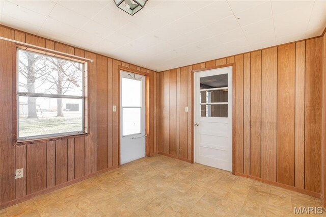 533 Locust St, Carrollton, IL 62016 - empty room featuring wood walls and tile patterned floors