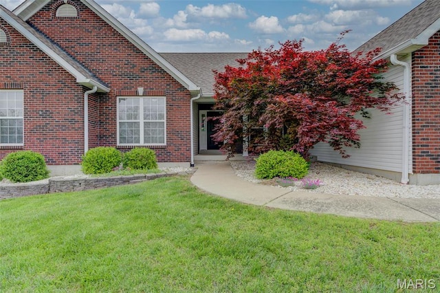 322 Gerard Ln, Moscow Mills, MO 63362 - entrance to property featuring a yard, a shingled roof, and brick siding