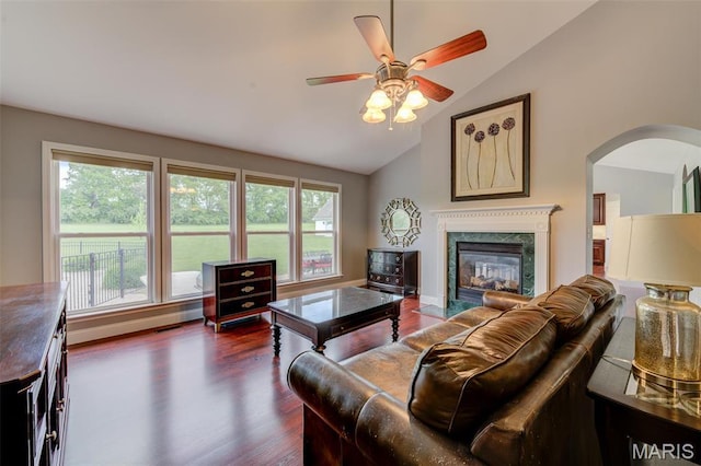 322 Gerard Ln, Moscow Mills, MO 63362 - living area featuring lofted ceiling, dark wood-style floors, arched walkways, a ceiling fan, and a fireplace