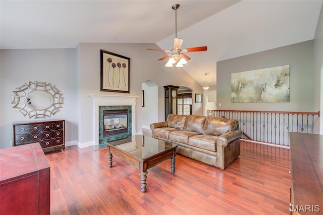 322 Gerard Ln, Moscow Mills, MO 63362 - living area with a ceiling fan, arched walkways, wood finished floors, vaulted ceiling, and a fireplace