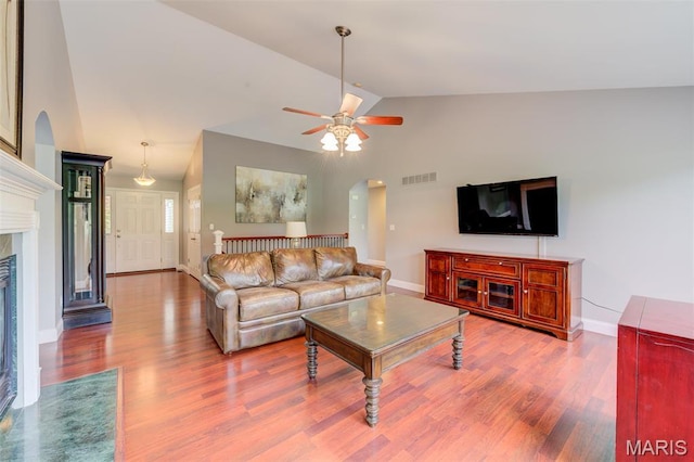 322 Gerard Ln, Moscow Mills, MO 63362 - living area with arched walkways, vaulted ceiling, wood finished floors, and baseboards