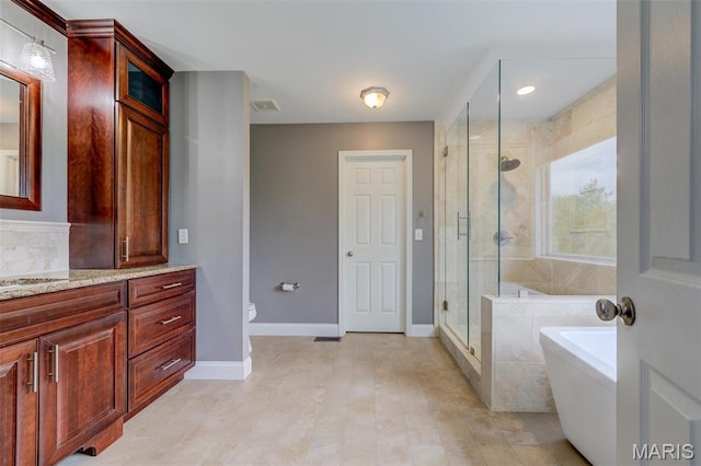 322 Gerard Ln, Moscow Mills, MO 63362 - full bathroom with vanity, a freestanding bath, a stall shower, toilet, and baseboards
