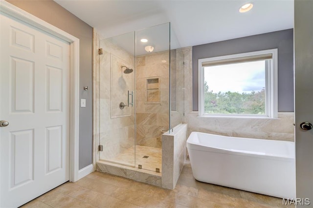 322 Gerard Ln, Moscow Mills, MO 63362 - full bathroom featuring a freestanding tub, a stall shower, tile patterned flooring, recessed lighting, and baseboards